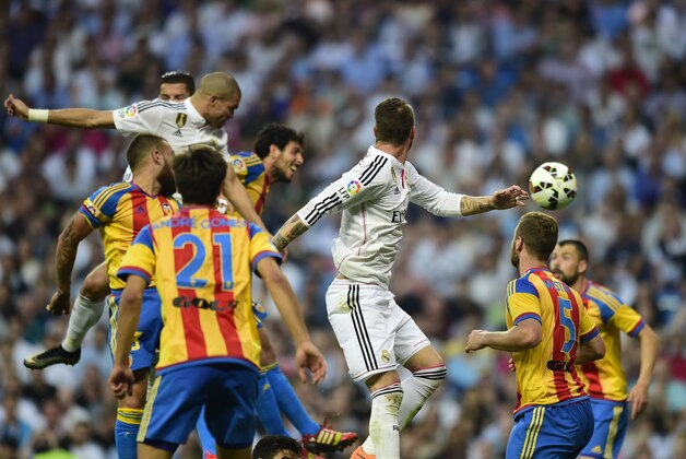 Real Madrid's Portuguese defender Pepe (L) heads the ball to score during the Spanish league football match Real Madrid CF vs Valencia CF at the Santiago Bernabeu stadium in Madrid on May 9, 2015.   AFP PHOTO/ PIERRE-PHILIPPE MARCOU        (Photo credit should read PIERRE-PHILIPPE MARCOU/AFP/Getty Images)