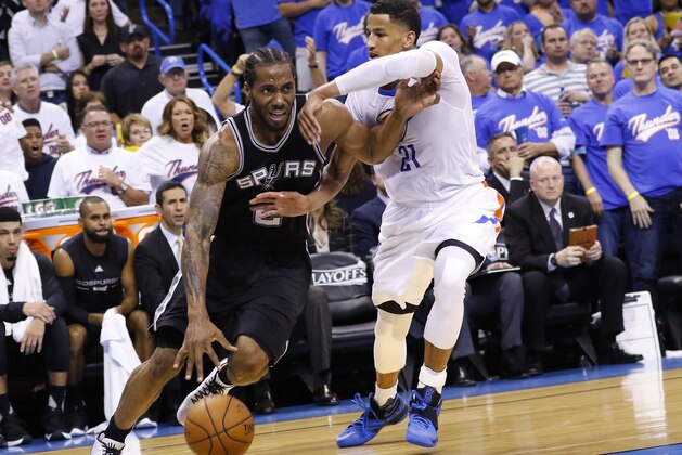 San Antonio Spurs forward Kawhi Leonard (2) drives to the basket around Oklahoma City Thunder guard Andre Roberson (21) during the second half of Game 3 of a second-round NBA basketball playoff series, Friday, May 6, 2016, in Oklahoma City. San Antonio won 100-96. (AP Photo/Alonzo Adams) San Antonio Spurs forward Kawhi Leonard (2) drives to the basket around Oklahoma City Thunder guard Andre Roberson (21) during the second half of Game 3 of a second-round NBA basketball playoff series, Friday, May 6, 2016, in Oklahoma City. San Antonio won 100-96. (AP Photo/Alonzo Adams)