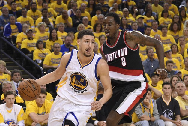 May 3, 2016; Oakland, CA, USA; Golden State Warriors guard Klay Thompson (11) dribbles the basketball against Portland Trail Blazers forward Al-Farouq Aminu (8) during the third quarter in game two of the second round of the NBA Playoffs at Oracle Arena. The Warriors defeated the Trail Blazers 110-99. Mandatory Credit: Kyle Terada-USA TODAY Sports