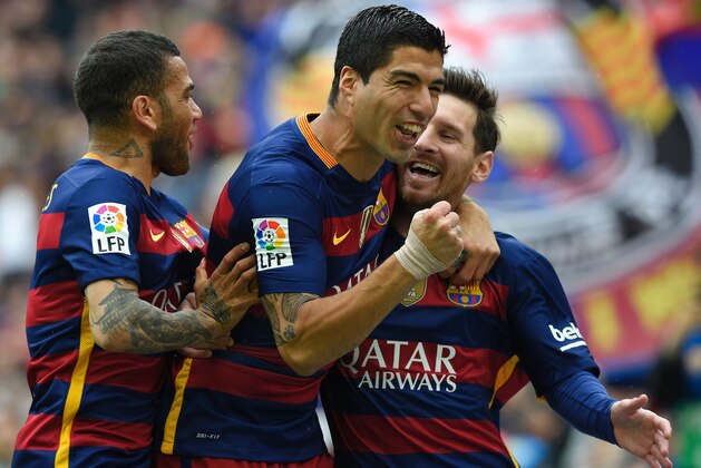 Barcelona's Argentinian forward Lionel Messi (R) celebrates with Barcelona's Uruguayan forward Luis Suarez (C) and Barcelona's Brazilian defender Dani Alves after scoring a goal during the Spanish league football match FC Barcelona vs RCD Espanyol at the Camp Nou stadium in Barcelona on May 8, 2016. / AFP / LLUIS GENE        (Photo credit should read LLUIS GENE/AFP/Getty Images)