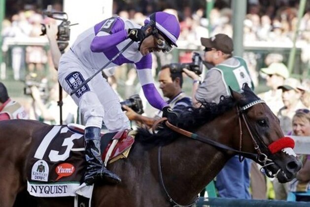 CORRECTS LAST NAME TO GUTIERREZ FROM GUITIERREZ - Mario Gutierrez celebrates after riding Nyquist to victory during the 142nd running of the Kentucky Derby horse race at Churchill Downs Saturday, May 7, 2016, in Louisville, Ky. (AP Photo/Garry Jones)