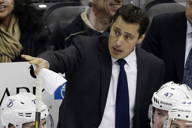 Tampa Bay Lightning head coach Guy Boucher gives instructions from behind his bench during the in the first period of an NHL hockey game against the Pittsburgh Penguins in Pittsburgh Sunday, Feb. 24, 2013. The Penguins won 5-3. (AP Photo/Gene J. Puskar)