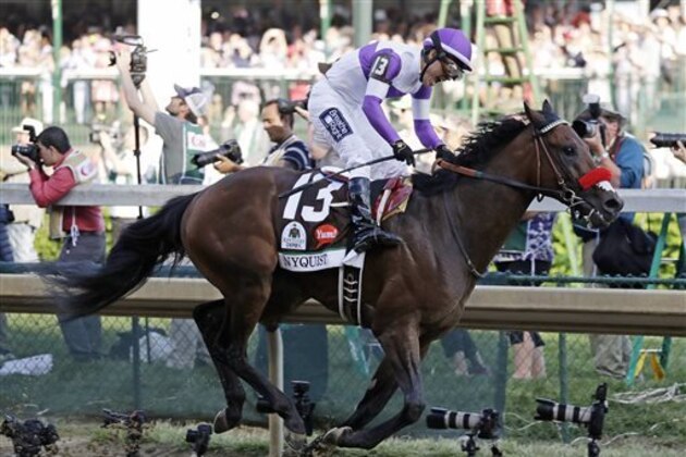 CORRECTS SPELLING OF LAST NAME TO GUTIERREZ FROM GUITIERREZ - Mario Gutierrez celebrates after riding Nyquist to victory during the 142nd running of the Kentucky Derby horse race at Churchill Downs, Saturday, May 7, 2016, in Louisville, Ky. (AP Photo/Garry Jones)