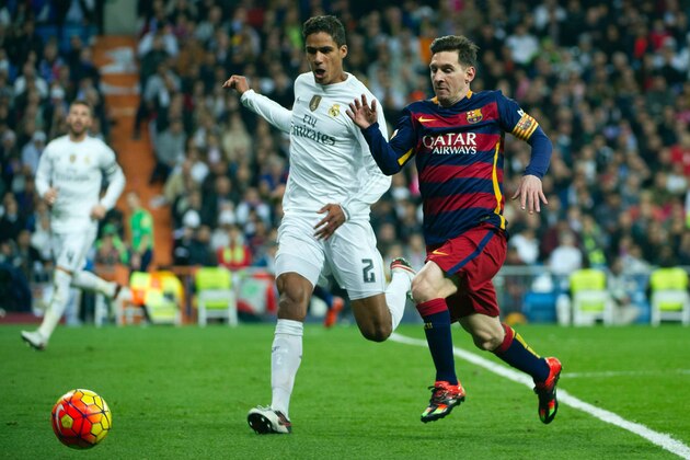 Barcelona's Argentinian forward Lionel Messi  (R) vies with Real Madrid's French defender Raphael Varane during the Spanish league 'Clasico' football match Real Madrid CF vs FC Barcelona at the Santiago Bernabeu stadium in Madrid on November 21, 2015.    AFP PHOTO / CURTO DE LA TORRE / AFP / CURTO DE LA TORRE        (Photo credit should read CURTO DE LA TORRE/AFP/Getty Images)