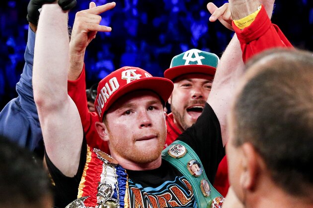 Canelo Alvarez celebrates his win against Amir Khan during their WBC middleweight title fight Saturday, May 7, 2016, in Las Vegas. (AP Photo/John Locher)