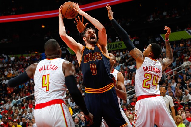 ATLANTA, GA - MAY 08:  Kevin Love #0 of the Cleveland Cavaliers drives the basket against Paul Millsap #4, Kent Bazemore #24 and Al Horford #15 of the Atlanta Hawks in Game Four of the Eastern Conference Semifinals during the 2016 NBA Playoffs at Philips Arena on May 8, 2016 in Atlanta, Georgia.  NOTE TO USER User expressly acknowledges and agrees that, by downloading and or using this photograph, user is consenting to the terms and conditions of the Getty Images License Agreement.  (Photo by Kevin C. Cox/Getty Images)