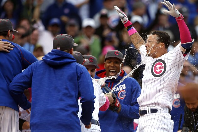 Chicago Cubs' Javier Baez, right, celebrates with teammates after hitting a baseball game-winning solo home run against the Washington Nationals during the 13th inning Sunday, May 8, 2016, in Chicago. (AP Photo/Nam Y. Huh)