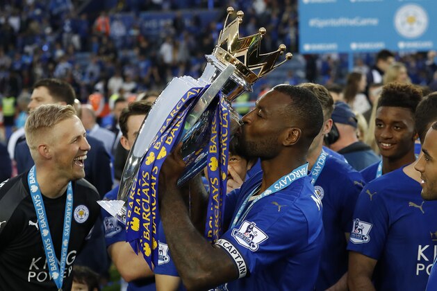 Leicester’s Wes Morgan kisses the trophy as Leicester City celebrate becoming the English Premier League soccer champions at King Power stadium in Leicester, England, Saturday, May 7, 2016.(AP Photo/Matt Dunham)