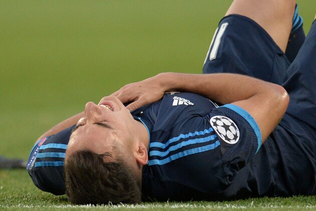 Real Madrid's midfielder Lucas Vazquez lies on the pitch after being hurt by a clearence by Manchester City's Belgian defender Vincent Kompany during the UEFA Champions League semi-final first leg football match between Manchester City and Real Madrid at the Etihad Stadium in Manchester, northwest England, on April 26, 2016. / AFP / OLI SCARFF        (Photo credit should read OLI SCARFF/AFP/Getty Images)