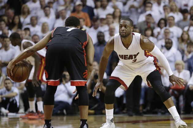 Miami Heat guard Dwyane Wade (3) defends Toronto Raptors guard Kyle Lowry (7), during the second half of Game 3 of an NBA second-round playoff basketball series Saturday, May 7, 2016, in Miami. (AP Photo/Alan Diaz)