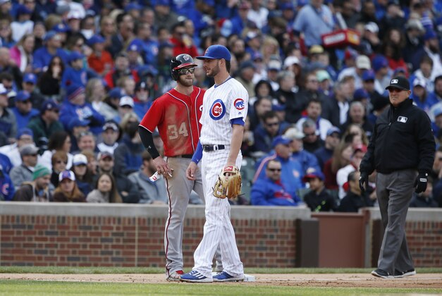 Washington Nationals' Bryce Harper, left, talks with Chicago Cubs third baseman Kris Bryant at third base during the fifth inning of a baseball game Saturday, May 7, 2016, in Chicago. (AP Photo/Nam Y. Huh)