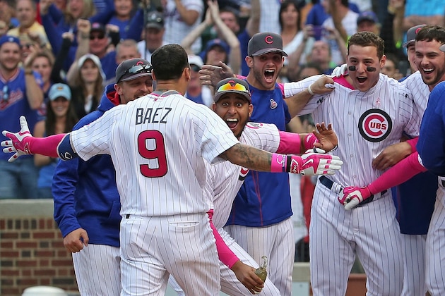 CHICAGO, IL - MAY 08: Javier Baez #9 of the Chicago Cubs is greeted by teammates after hitting the game-winning, walk off home run against the Washington Nationals at Wrigley Field on May 8, 2016 in Chicago, Illinois. The Cubs defeated the Nationals 4-3 in 13 innings.  (Photo by Jonathan Daniel/Getty Images)
