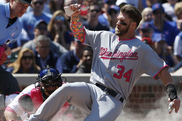 Washington Nationals' Bryce Harper, right, scores on a double by Ryan Zimmerman as Chicago Cubs catcher Tim Federowicz, center, applies a late tag during the third inning of a baseball game Sunday, May 8, 2016, in Chicago. (AP Photo/Nam Y. Huh)