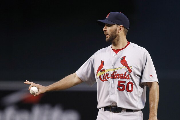 St. Louis Cardinals' Adam Wainwright talks to an infielder during the first inning of a baseball game against the Arizona Diamondbacks Wednesday, April 27, 2016, in Phoenix.  The Cardinals defeated the Diamondbacks 11-4. (AP Photo/Ross D. Franklin)