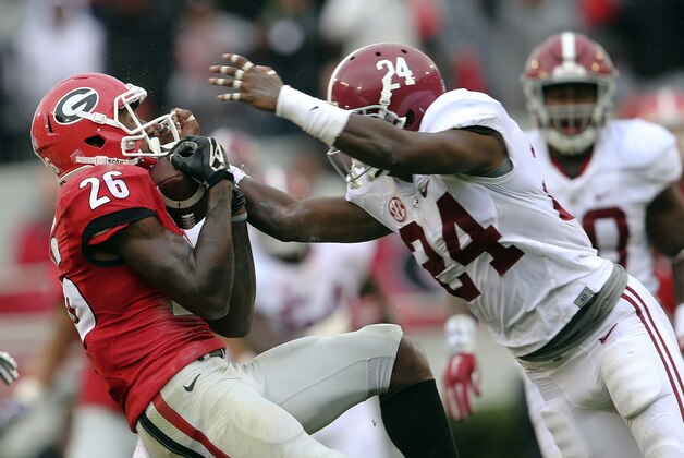 Georgia wide receiver Malcolm Mitchell (26) makes a catch as Alabama defensive back Geno Matias-Smith (24) defends in the first half of an NCAA college football game, Saturday, Oct. 3, 2015, in Athens, Ga. (AP Photo/John Bazemore)