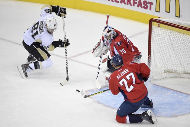 Pittsburgh Penguins right wing Phil Kessel (81) battles for the puck against Washington Capitals goalie Braden Holtby (70) and Karl Alzner (27) during the first period of Game 5 in an NHL hockey Stanley Cup Eastern Conference semifinals, Saturday, May 7, 2016, in Washington. (AP Photo/Nick Wass)