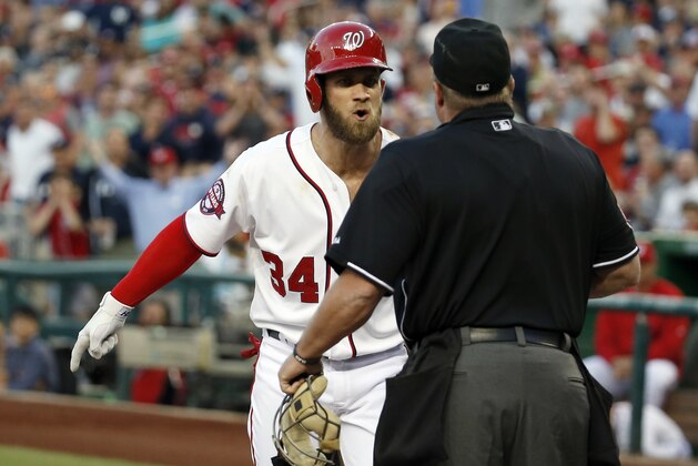 Washington Nationals' Bryce Harper (34) argues with home plate umpire Marvin Hudson during the third inning of a baseball game against the New York Yankees at Nationals Park, Wednesday, May 20, 2015, in Washington. Harper and manager Matt Williams were ejected by Hudson. (AP Photo/Alex Brandon)