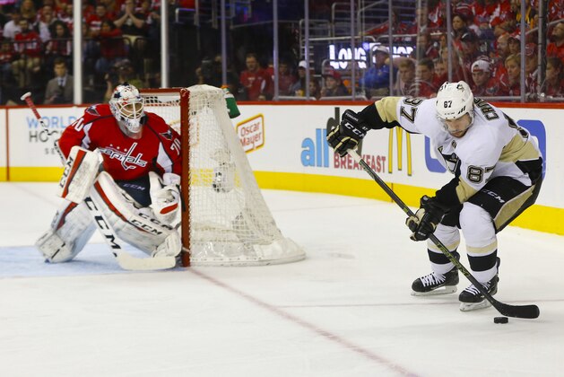 Pittsburgh Penguins center Sidney Crosby (87) with the puck near the net of Washington Capitals goalie Braden Holtby (70) during the third period of Game 5 in an NHL hockey Stanley Cup Eastern Conference semifinals Saturday, May 7, 2016 in Washington. Capitals won 3-1. (AP Photo/Pablo Martinez Monsivais)