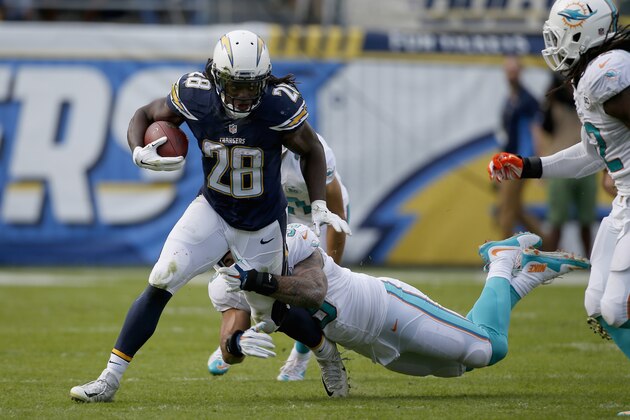 SAN DIEGO, CA - DECEMBER 20:   Melvin Gordon #28 of the San Diego Chargers runs against  Bobby McCain #28 of the Miami Dolphins at Qualcomm Stadium on December 20, 2015 in San Diego, California.  (Photo by Todd Warshaw/Getty Images)