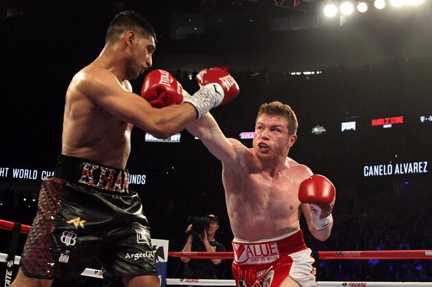 Saul Canelo Alvarez (R) of Mexico connects a right against Amir Khan (L) of Great Britain during their WBC Middleweight Championship fight at the T-Mobile Arena, Saturday, May 7, 2016 in Las Vegas, Nevada. 
Saul Canelo Alvarez successfully defended his World Boxing Council middleweight title in spectacular fashion with a devastating sixth-round knockout of Amir Khan in Las Vegas.
The 25-year-old Mexican dropped Khan with a straight right hand over a left jab that sent the Briton crumbling to the canvas with just 23 seconds left in the round. 
 / AFP / John Gurzinski        (Photo credit should read JOHN GURZINSKI/AFP/Getty Images)