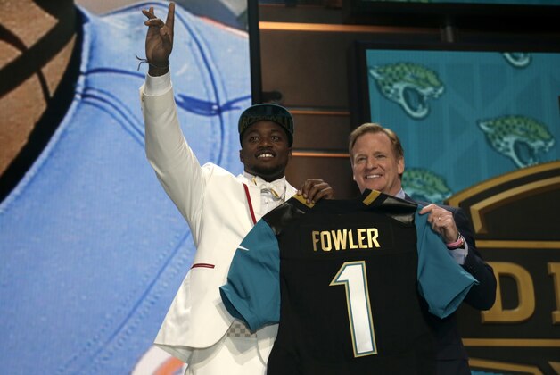Dante Fowler, left, stands with NFL commissioner Roger Goodell, right, on stage after being drafted third by Jacksonville in the first round of the 2015 NFL Draft, Thursday, April 30, 2015, in Chicago.  (Jeff Haynes/AP Images for Panini)
