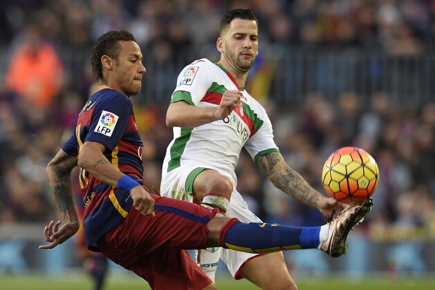 Barcelona's Brazilian forward Neymar (L) vies with Granada's midfielder Edgar (R) during the Spanish league football match FC Barcelona vs Granada CF at the Camp Nou stadium in Barcelona on January 9, 2016.   AFP PHOTO / LLUIS GENE / AFP / LLUIS GENE        (Photo credit should read LLUIS GENE/AFP/Getty Images)