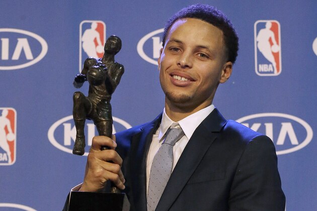 FILE - In this May 4, 2015, file photo, Golden State Warriors guard Stephen Curry holds the NBA's Most Valuable Player award at a basketball news conference in Oakland, Calif. Curry is the first unanimous NBA MVP, earning the award for the second straight season, Tuesday, May 10, 2016.  (AP Photo/Jeff Chiu, File)