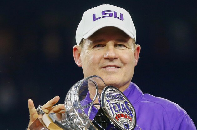 LSU head coach Les Miles holds up the championship trophy after the defeated Texas Tech during the Texas Bowl NCAA football game Tuesday, Dec. 29, 2015, in Houston. (AP Photo/Bob Levey)