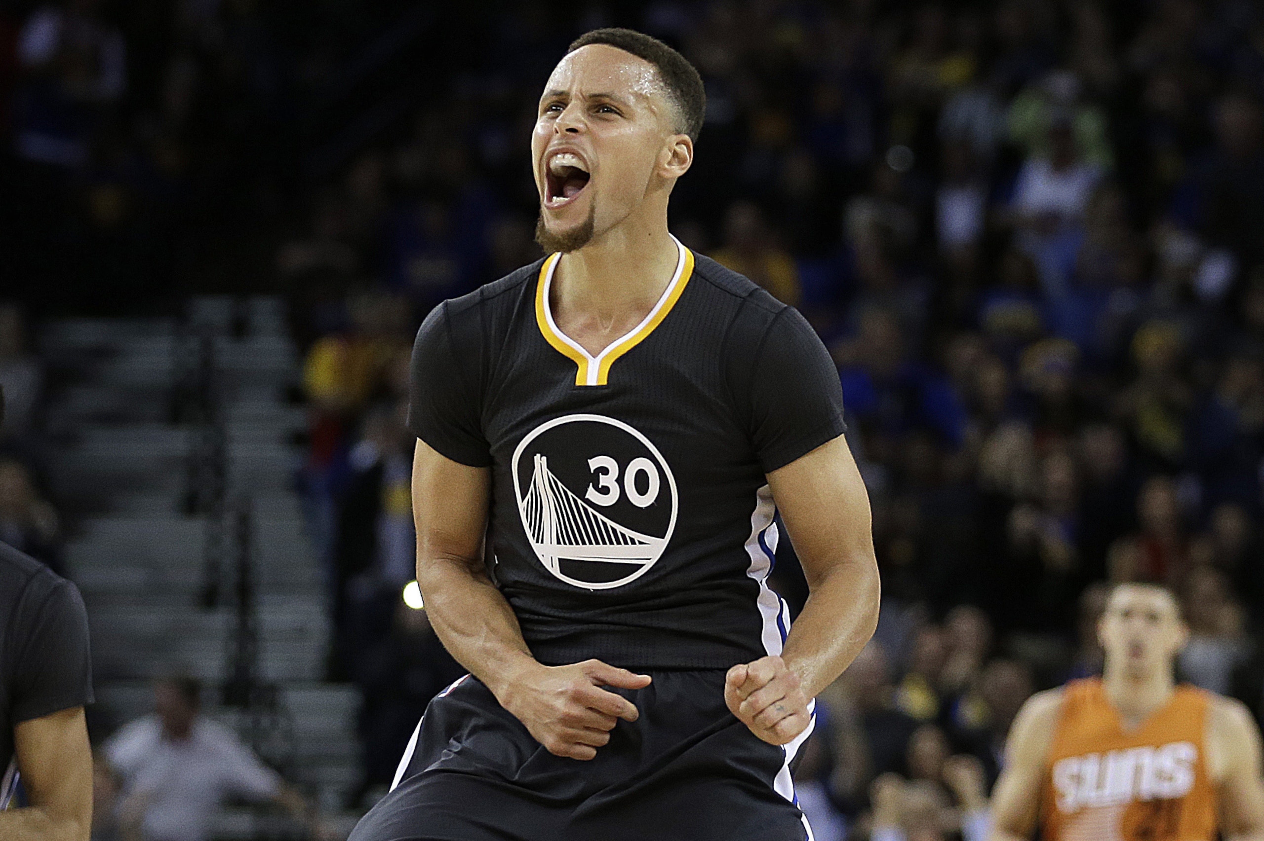Golden State Warriors' Stephen Curry celebrates a score against the Phoenix Suns in the final seconds of the NBA basketball game Saturday, March 12, 2016, in Oakland, Calif. (AP Photo/Ben Margot)