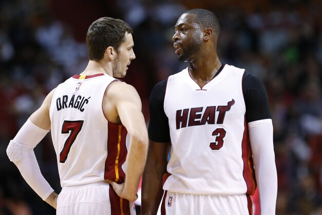 Miami Heat guard Goran Dragic (7) and guard Dwyane Wade (3) talk during the first half of an NBA basketball game against the Orlando Magic, Sunday, April 10, 2016, in Miami. (AP Photo/Wilfredo Lee)