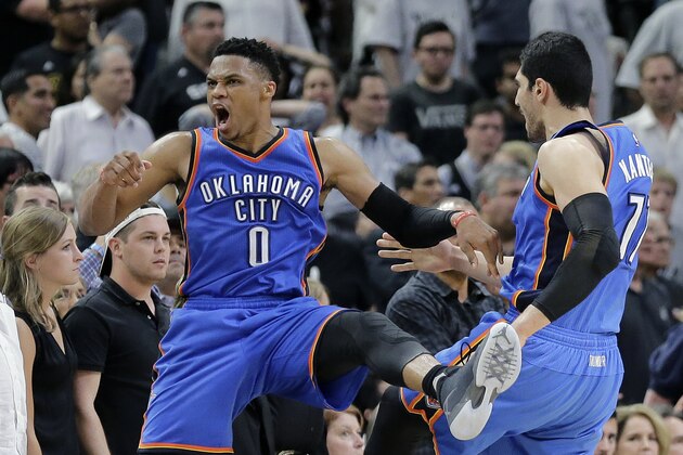Oklahoma City Thunder guard Russell Westbrook (0) celebrates with teammate Enes Kanter (11) after he scored against the San Antonio Spurs during the final seconds of Game 5 of a second-round NBA basketball playoff series, Tuesday, May 10, 2016, in San Antonio. Oklahoma City won 95-91. (AP Photo/Eric Gay)