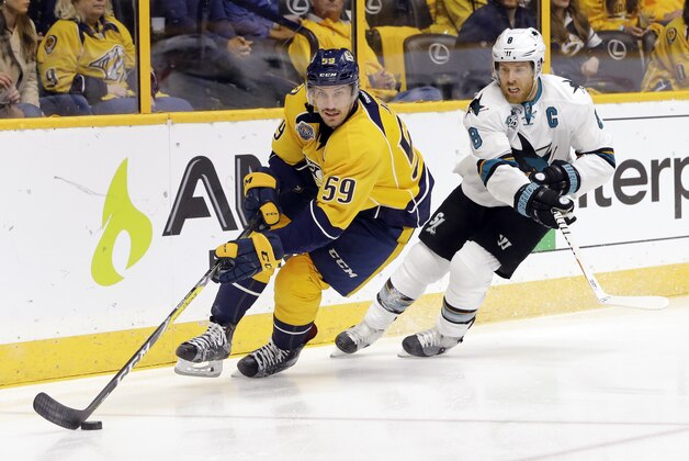 Nashville Predators defenseman Roman Josi (59), of Switzerland, moves the puck against San Jose Sharks center Joe Pavelski (8) in the first period of Game 4 of an NHL hockey Stanley Cup Western Conference semifinal playoff series Thursday, May 5, 2016, in Nashville, Tenn. (AP Photo/Mark Humphrey)