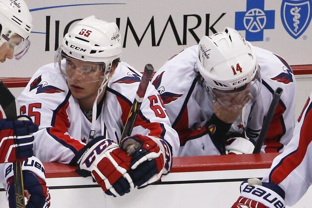 Washington Capitals' Andre Burakovsky (65) and Justin Williams (14) sit on the bench after the Capitals lost to the Pittsburgh Penguins in overtime of Game 6 of the NHL hockey Stanley Cup Eastern Conference semifinals, Tuesday, May 10, 2016 in Pittsburgh. The Penguins won 4-3 and advanced to the conference finals. (AP Photo/Gene J. Puskar)