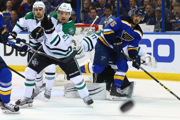 ST. LOUIS, MO - MAY 3: Antoine Roussel #21 of the Dallas Stars clears the puck against Robby Fabbri #15 of the St. Louis Blues in Game Three of the Western Conference Second Round during the 2016 NHL Stanley Cup Playoffs at the Scottrade Center on May 3, 2016 in St. Louis, Missouri.  (Photo by Dilip Vishwanat/Getty Images)