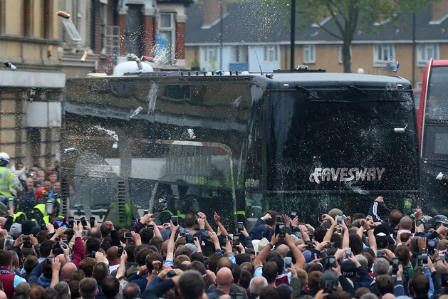 LONDON, ENGLAND - MAY 10:  Fans congregate in the street and throw bottles and cans at the Manchester United team bus prior to the Barclays Premier League match between West Ham United and Manchester United at the Boleyn Ground on May 10, 2016 in London, United Kingdom.  (Photo by Catherine Ivill - AMA/Getty Images)