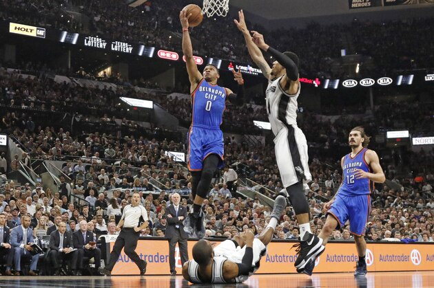 SAN ANTONIO,TX - MAY 10:  Russell Westbrook #0 of the Oklahoma City Thunder scores over a fallen Patty Mills #24 of the San Antonio Spurs n game Five of the Western Conference Semifinals during the 2016 NBA Playoffs at AT&T Center on May 10, 2016 in San Antonio, Texas.  NOTE TO USER: User expressly acknowledges and agrees that , by downloading and or using this photograph, User is consenting to the terms and conditions of the Getty Images License Agreement. (Photo by Ronald Cortes/Getty Images)