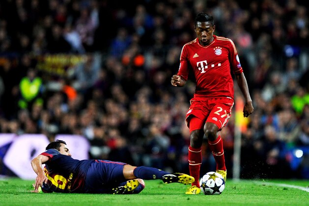 BARCELONA, SPAIN - MAY 01:  David Alaba of Munich is tackled by Xavi Hernandez of Barcelona during the UEFA Champions League semi final second leg match between Barcelona and FC Bayern Muenchen at Nou Camp on May 1, 2013 in Barcelona, Spain.  (Photo by David Ramos/Getty Images)