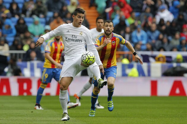 Real Madrid's James Rodriguez, left, controls the ball in front of Valencia's Javi Fuego during a Spanish La Liga soccer match between Real Madrid and Valencia at the Santiago Bernabeu stadium in Madrid, Spain, Sunday, May 8, 2016. (AP Photo/Paul White)