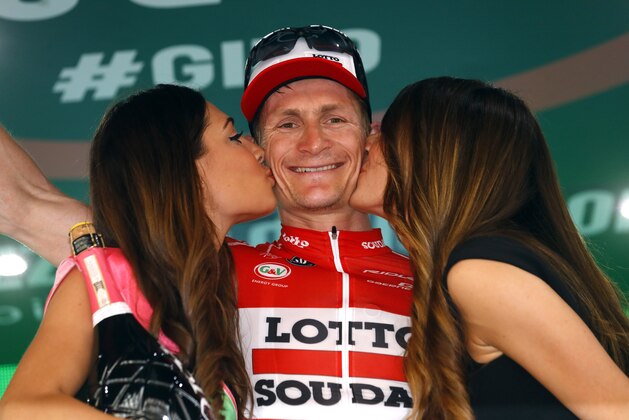 German cyclist Andre Greipel of Lotto Soudal team is kissed by hostesses as he celebrates on the podium after winning the 233km fifth stage between Praia a Mare and Benevento, during the 99th Giro d'Italia, Tour of Italy, on May 11, 2016 in Benevento. / AFP / LUK BENIES        (Photo credit should read LUK BENIES/AFP/Getty Images)