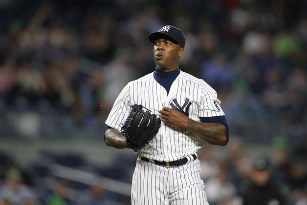 New York Yankees relief pitcher Aroldis Chapman, the first player disciplined under Major League Baseball's domestic violence policy, reacts on the mound during the ninth inning of a baseball game against the Kansas City Royals at Yankee Stadium in New York, Monday, May 9, 2016.  The Yankees defeated the Royals 6-3. (AP Photo/Kathy Willens)