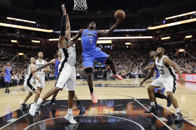 Oklahoma City Thunder guard Dion Waiters (3) scores over San Antonio Spurs forward LaMarcus Aldridge (12) during the second half in Game 5 of a second-round NBA basketball playoff series, Tuesday, May 10, 2016, in San Antonio. (AP Photo/Eric Gay)