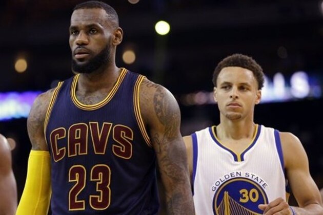 Cleveland Cavaliers forward LeBron James (23) walks in front of Golden State Warriors guard Stephen Curry (30) during the first half of Game 5 of basketball's NBA Finals in Oakland, Calif., Sunday, June 14, 2015. (AP Photo/Ben Margot)
