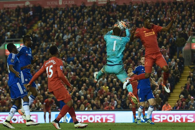 Chelsea's Bosnian goalkeeper Asmir Begovic catches the ball under pressure from Liverpool's Zaire-born Belgian striker Christian Benteke (R) during the English Premier League football match between Liverpool and Chelsea at Anfield in Liverpool, north west England on May 11, 2016. / AFP / Paul ELLIS / RESTRICTED TO EDITORIAL USE. No use with unauthorized audio, video, data, fixture lists, club/league logos or 'live' services. Online in-match use limited to 75 images, no video emulation. No use in betting, games or single club/league/player publications.  /         (Photo credit should read PAUL ELLIS/AFP/Getty Images)