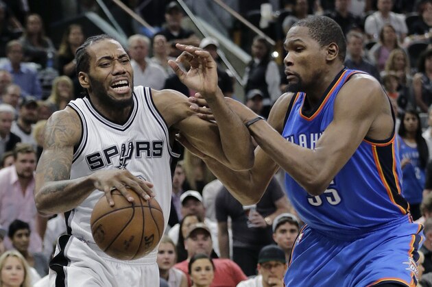 San Antonio Spurs forward Kawhi Leonard drives against Oklahoma City Thunder forward Kevin Durant (35) during the second half in Game 5 of a second-round NBA basketball playoff series, Tuesday, May 10, 2016, in San Antonio. Oklahoma City won 95-91. (AP Photo/Eric Gay)