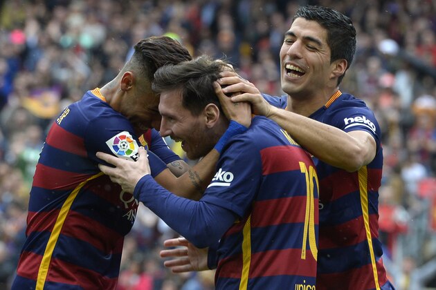 Barcelona's Argentinian forward Lionel Messi (C) celebrates with Barcelona's Brazilian forward Neymar and Barcelona's Uruguayan forward Luis Suarez (R) after scoring a goal during the Spanish league football match FC Barcelona vs RCD Espanyol at the Camp Nou stadium in Barcelona on May 8, 2016. / AFP / LLUIS GENE        (Photo credit should read LLUIS GENE/AFP/Getty Images)