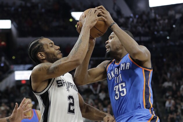 Oklahoma City Thunder forward Kevin Durant (35) is defended by San Antonio Spurs forward Kawhi Leonard (2) as he drives to the basket during the first half in Game 5 of a second-round NBA basketball playoff series, Tuesday, May 10, 2016, in San Antonio. (AP Photo/Eric Gay)
