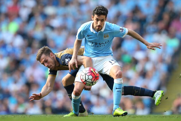 MANCHESTER, ENGLAND - MAY 08:  Jesus Navas of Manchester City holds off Aaron Ramsey of Arsenal during the Barclays Premier League match between Manchester City and Arsenal at the Etihad Stadium on May 8, 2016 in Manchester, England.  (Photo by Alex Livesey/Getty Images)
