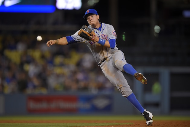 New York Mets second baseman Wilmer Flores attempts to throw out Los Angeles Dodgers' Charlie Culberson at first during the fourth inning of a baseball game, Monday, May 9, 2016, in Los Angeles. Culberson was safe at first on the play. (AP Photo/Mark J. Terrill)