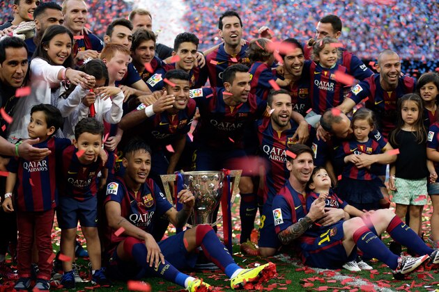 FC Barcelona players, with their children, pose with their trophy after winning the Spanish League title, at the end of their Spanish La Liga last round soccer match against Deportivo Coruna at the Camp Nou stadium in Barcelona, Spain, Saturday, May 23, 2015. (AP Photo/Manu Fernandez) FC Barcelona players, with their children, pose with their trophy after winning the Spanish League title, at the end of their Spanish La Liga last round soccer match against Deportivo Coruna at the Camp Nou stadium in Barcelona, Spain, Saturday, May 23, 2015. (AP Photo/Manu Fernandez)