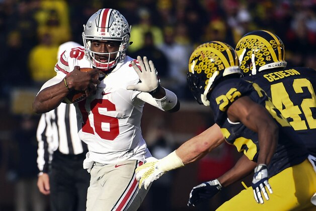 Nov 28, 2015; Ann Arbor, MI, USA; Ohio State Buckeyes quarterback J.T. Barrett (16) rushes in the second half against the Michigan Wolverines at Michigan Stadium. Ohio State won 42-13. Mandatory Credit: Tim Fuller-USA TODAY Sports